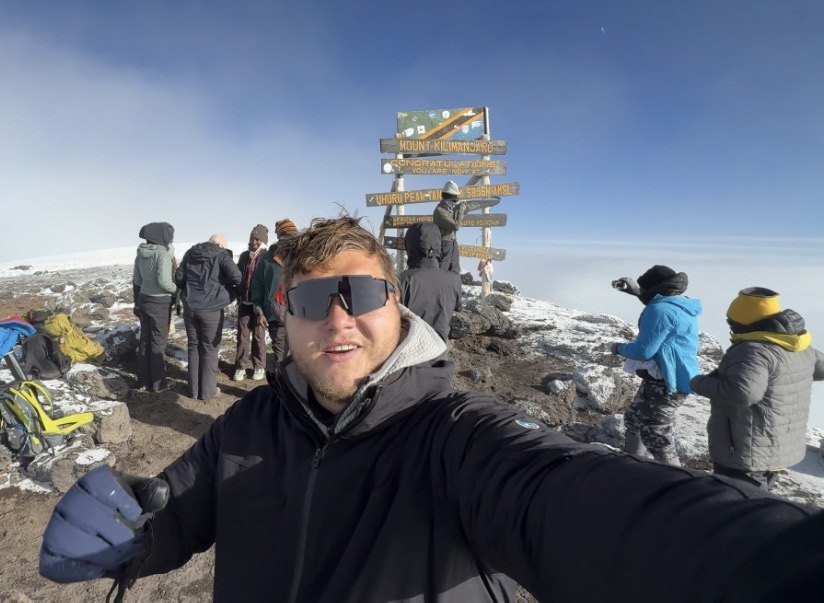 Alex Petersen on the summit of Mount Kilimanjaro